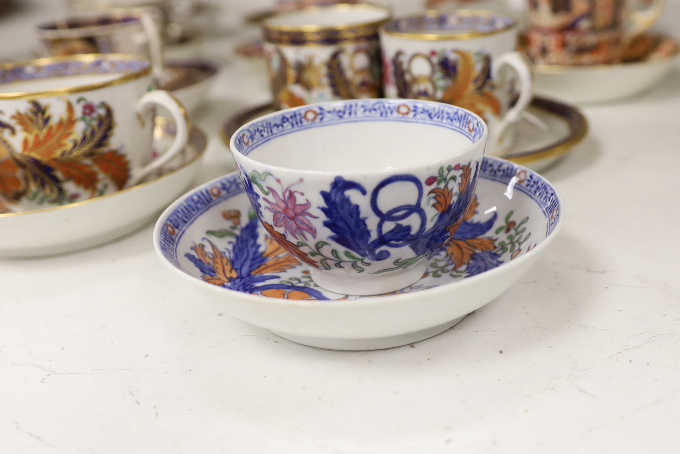 Six mixed English 1800-1820 porcelain cabinet cups and saucers, three similar coffee cans and saucers, a matching spoon stand and two coffee cans, a saucer dish, coffee can plus saucer and a tea bowl and matching saucer